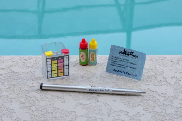 Full extendable pool test kit laid out on the pool edge